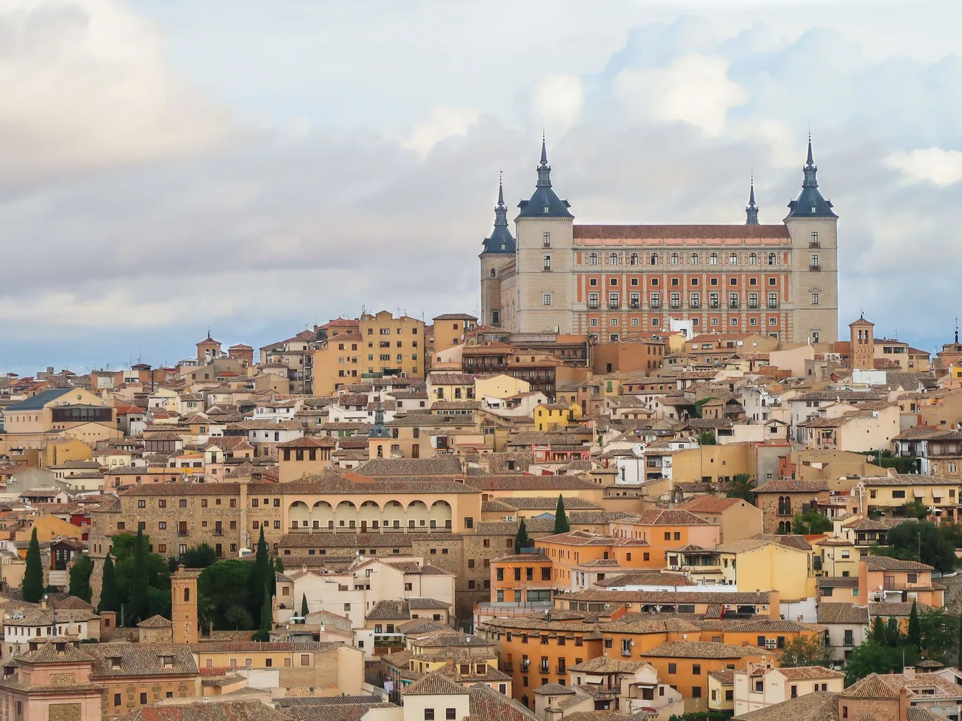 The Alcázar fortress rising above the rooftops of Toledo